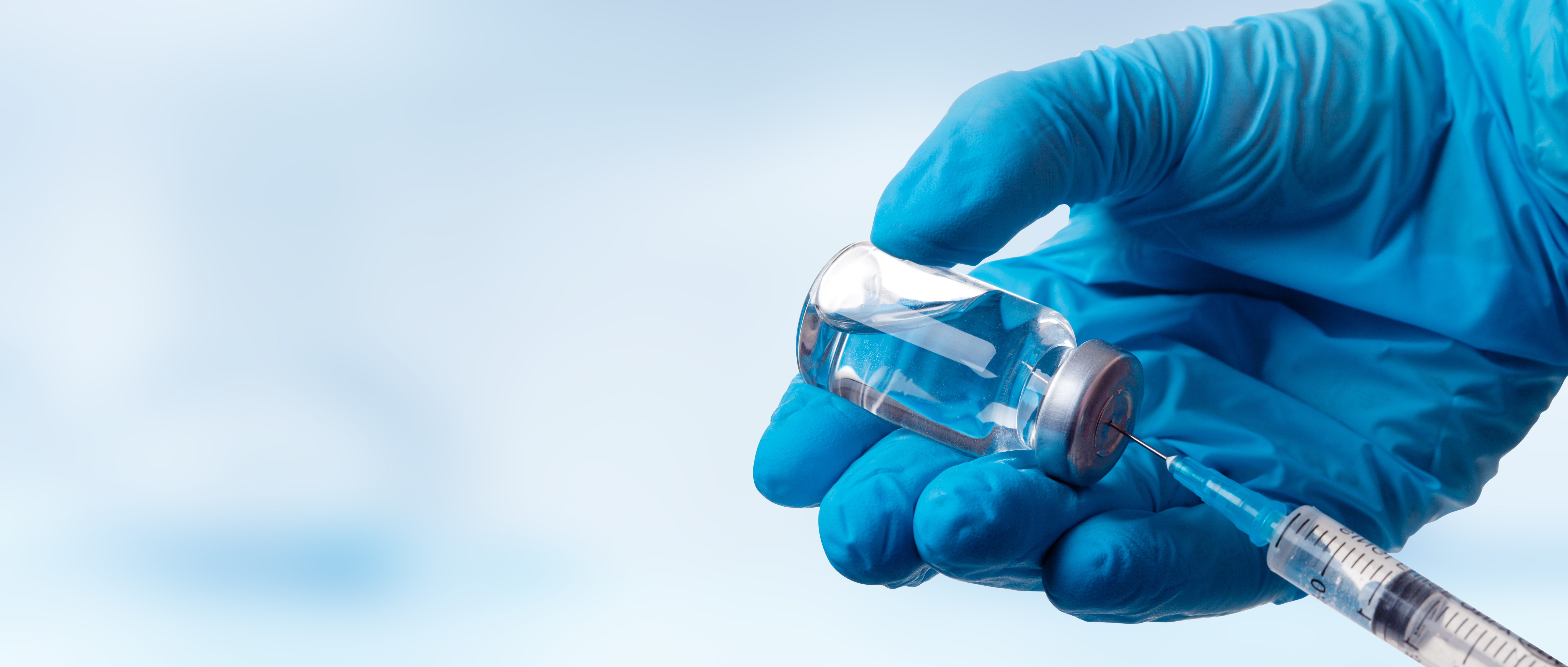 Hand holding viol with vaccine against corona virus. Advancements in HPV Treatment